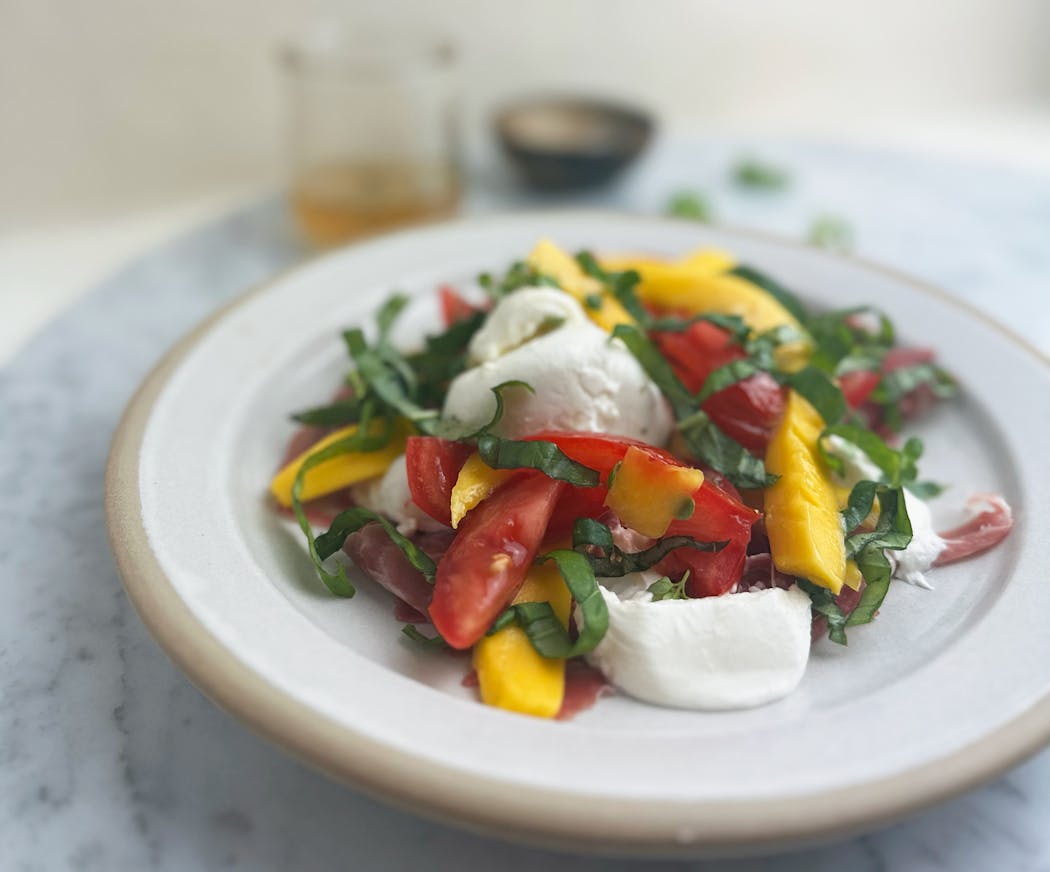 Burrata, Mango and Tomato Salad is a quick summer meal that beats the heat.