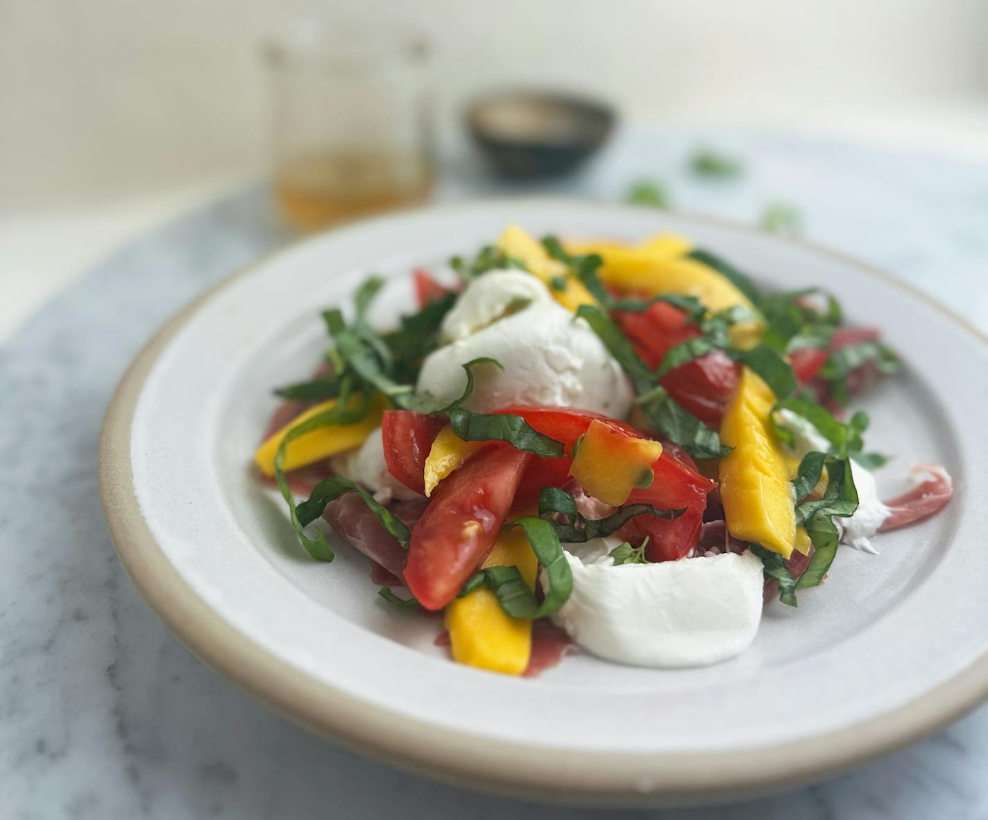 Burrata, Mango and Tomato Salad is a quick summer meal that beats the heat. Recipe and photo by Alyssa Shultis, special to the Star Tribune