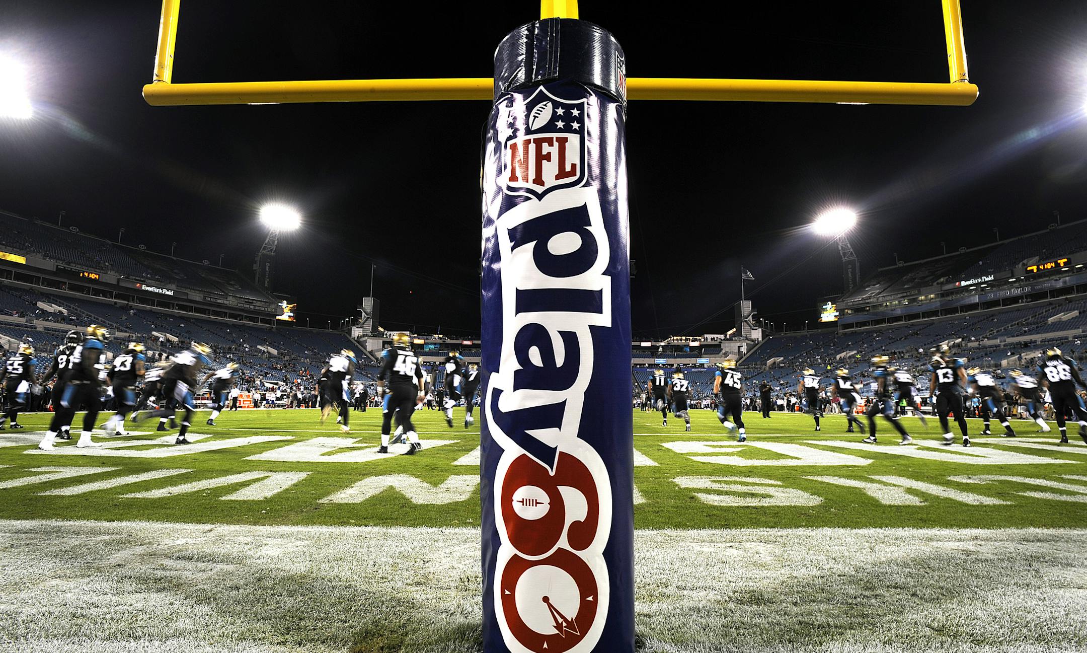 Members of the Jacksonville Jaguars warm up near the Play 60 goal post pad on EverBank Field before the start of an NFL football game against the Houston Texans, Thursday, Dec. 5, 2013, in Jacksonville, Fla. (AP Photo/Stephen Morton)