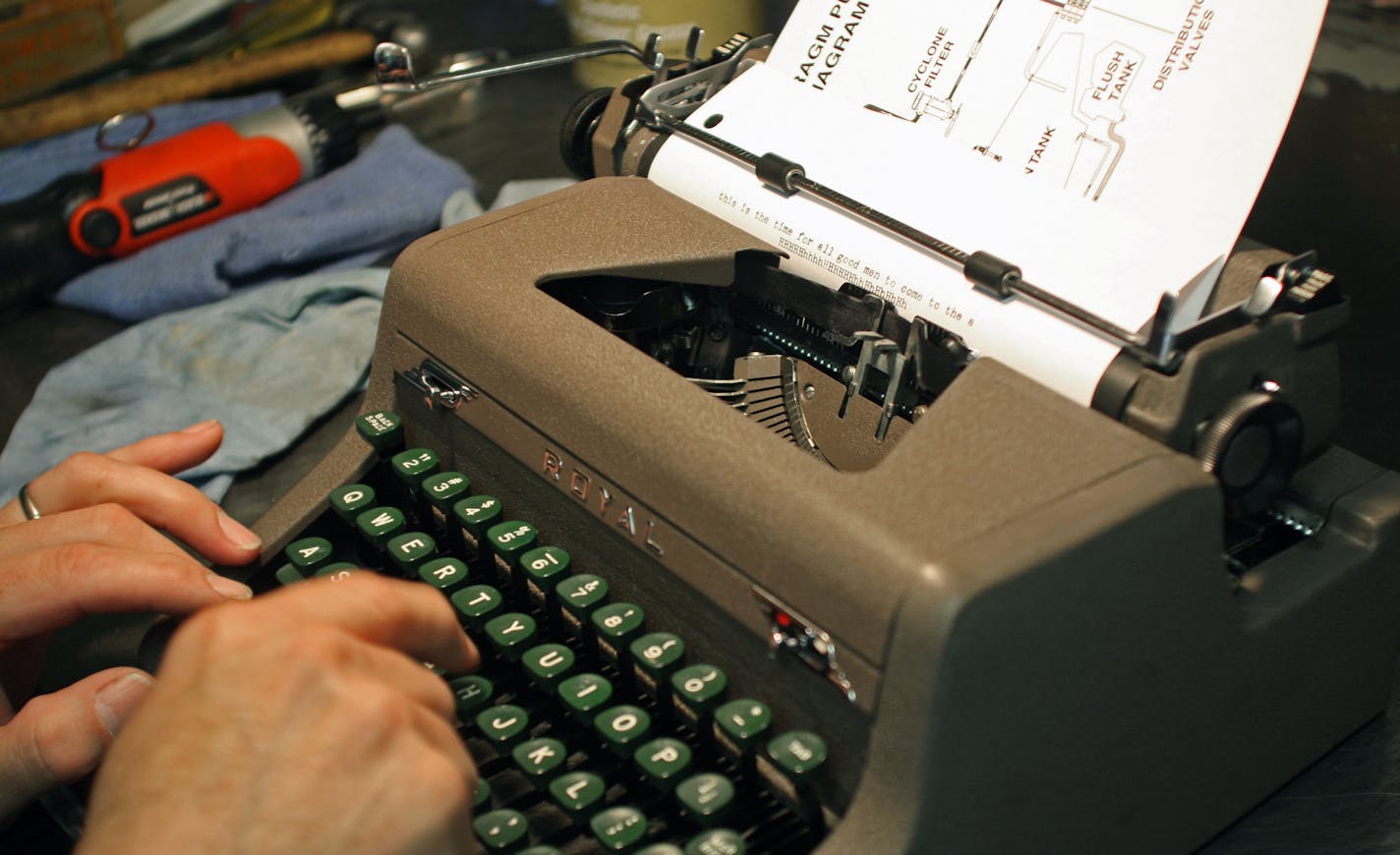 Soderbeck gave a last check to a newly repaired 1940s Royal portable model. Thirty years ago, Soderbeck was working 80-hour weeks trying to fix all the typewriters that came into his shop for repair; these days he commutes to the city from his farm just for the joy of it.