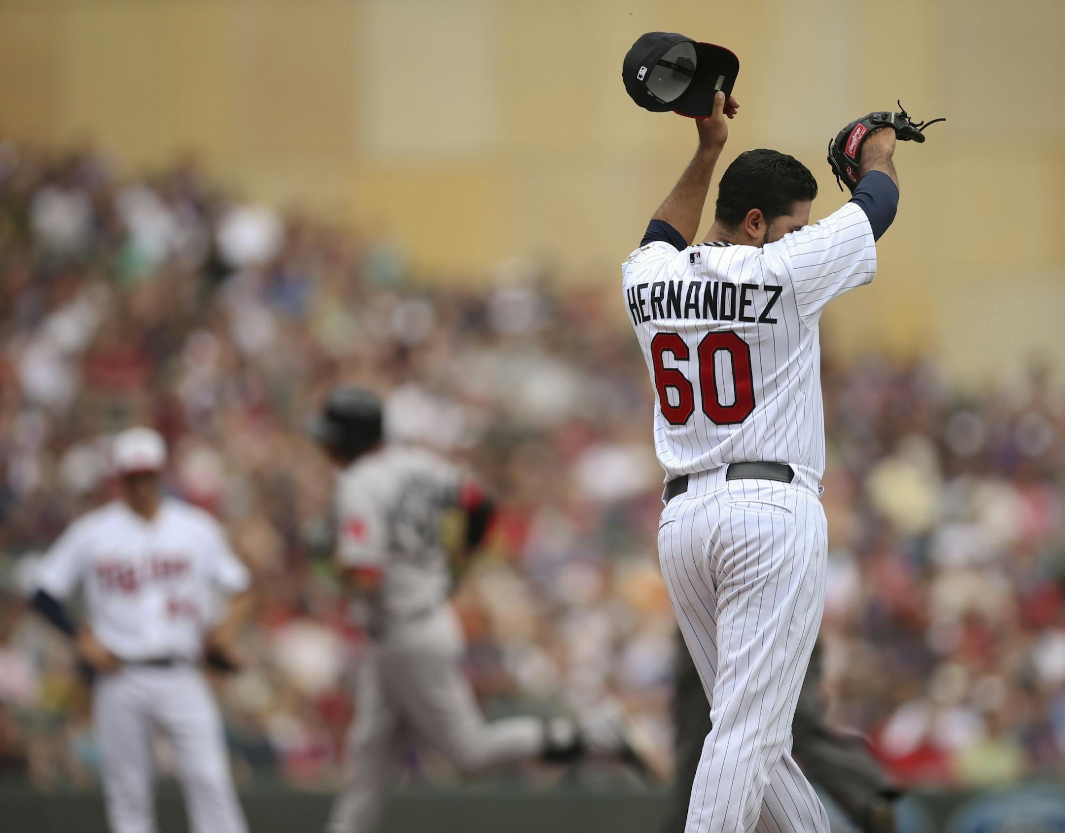 Pedro Hernandez wiped his brow after giving up a solo home run to the Red Sox's Will Middlebrooks, rear, in the second inning Sunday afternoon.