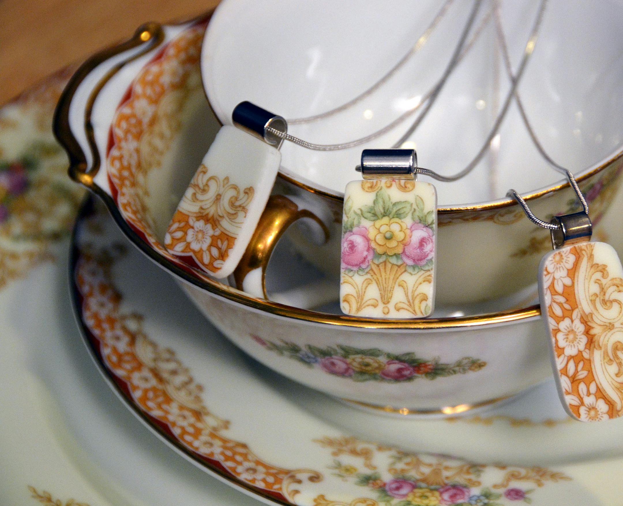 Three of the broken china pendants Mary Protas commissioned are displayed on pieces of her grandmother's china. ] Joey McLeister,Special to the Star Tribune,Coon Rapids,MN January 23,2013