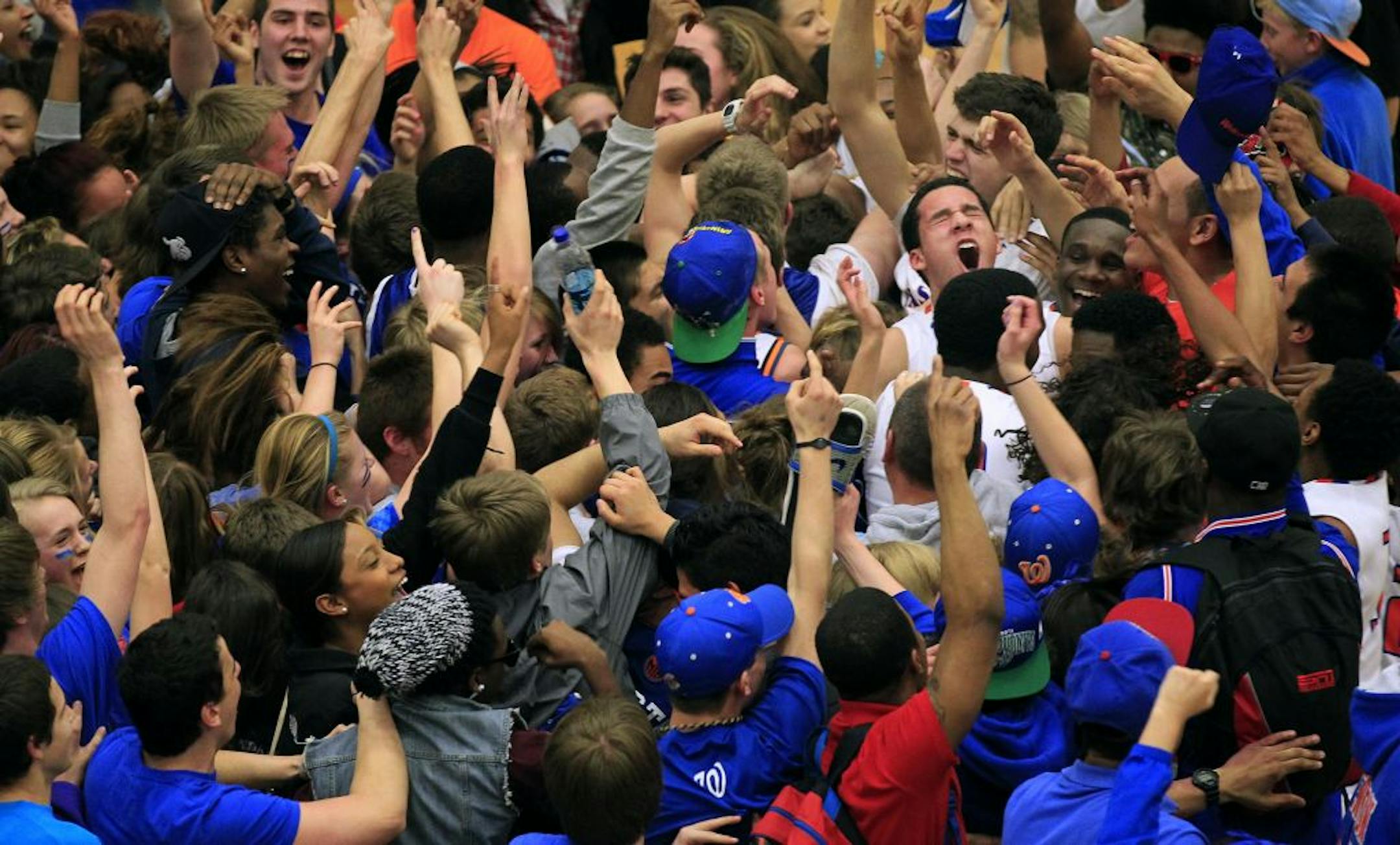 Minneapolis Washburn players celebrated with their fans at the end of the section final game after defeating Benilde St. Margaret's 71-66.