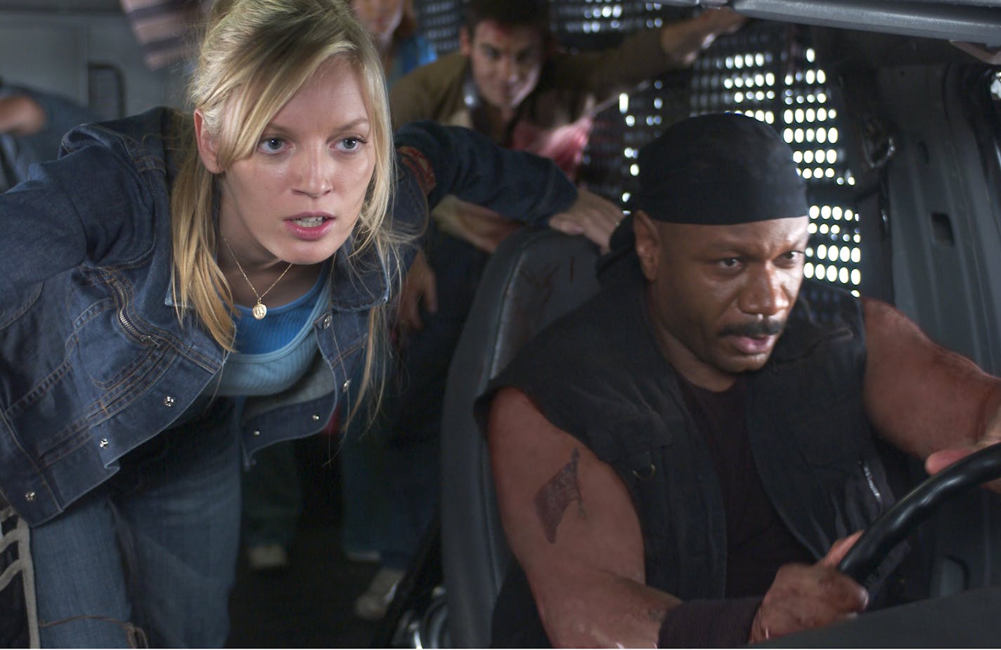 Sarah Polley, Ving Rhames and the last remaining survivors drive out of their mall fortress in makeshift armored vehicles in the zombie action thriller "Dawn of the Dead."