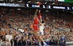 Texas Tech guard Brandone Francis (1) shoots over Virginia Cavaliers guard Ty Jerome (11) during the first half of the NCAA Championship game Monday, 