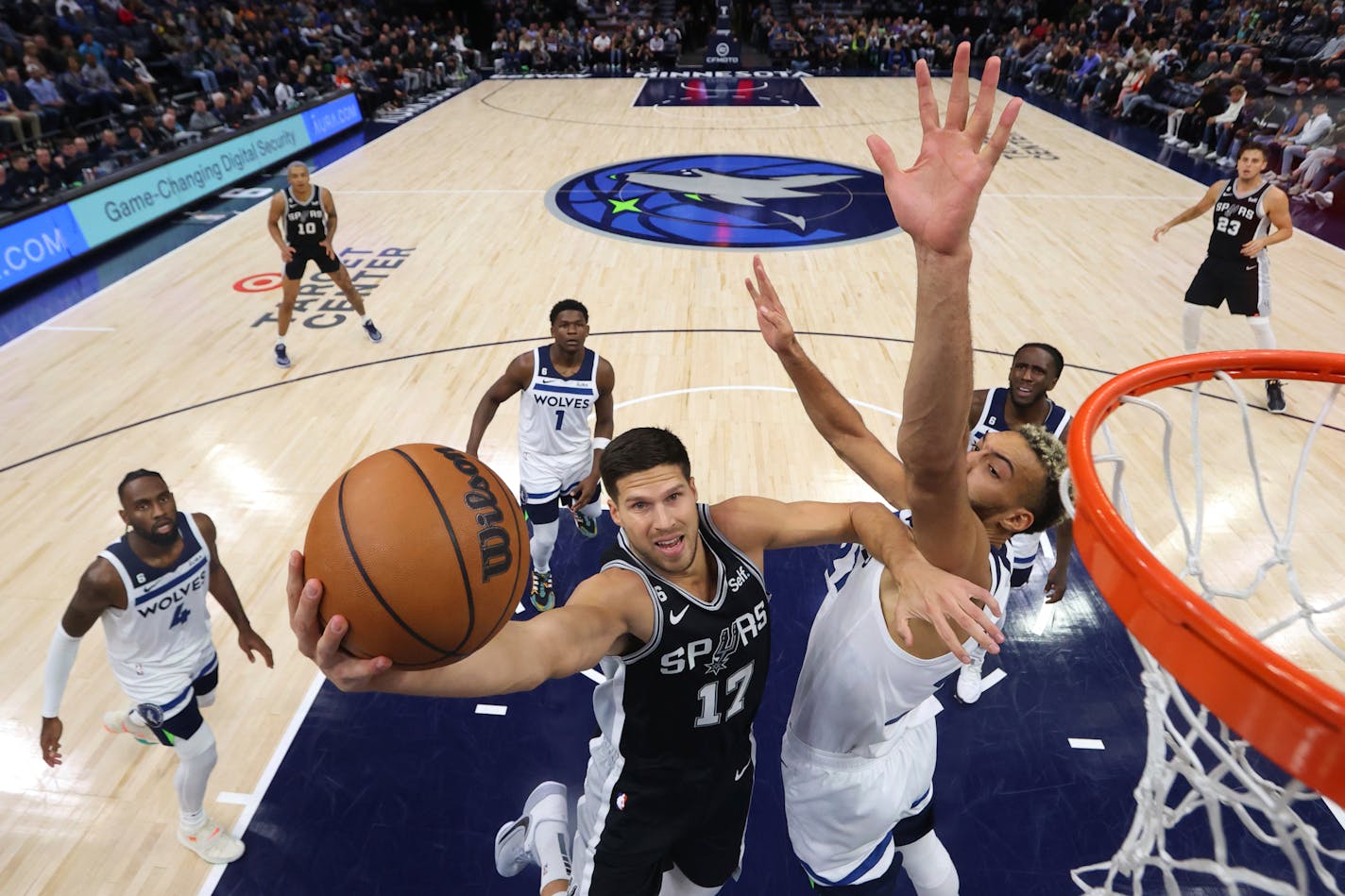 San Antonio Spurs forward Doug McDermott (17) shoots over Minnesota Timberwolves center Rudy Gobert, front right, during the first half of an NBA basketball game, Monday, Oct. 24, 2022, in Minneapolis. (AP Photo/Abbie Parr)