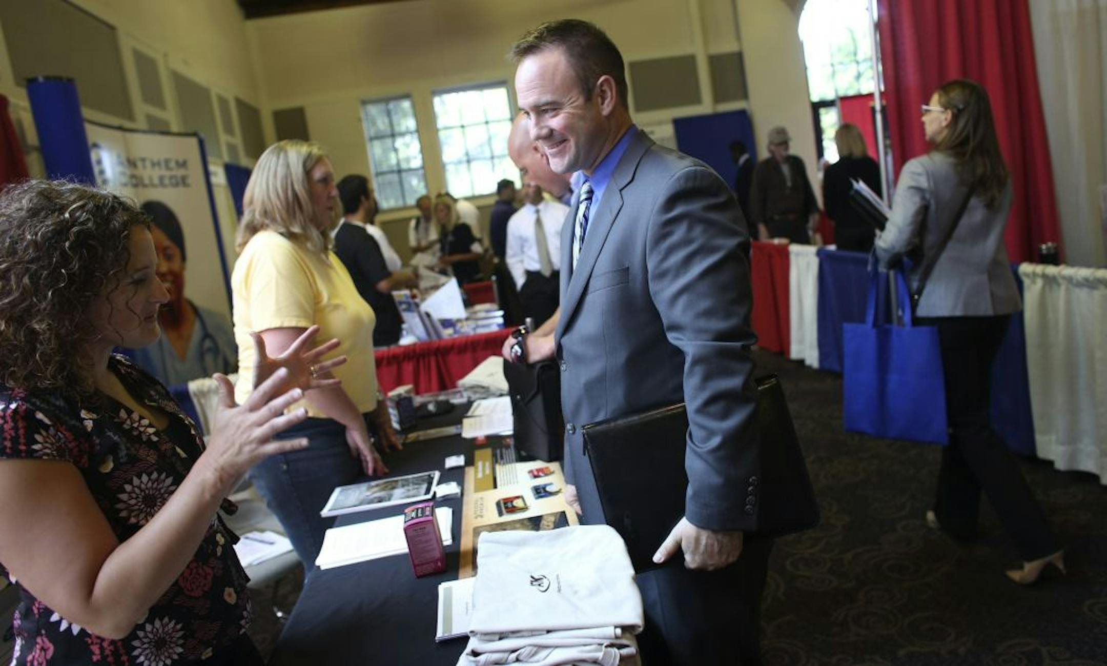 Robb Lutz of St. Paul, a member of the Minnesota National Guard, talked with Jenny Nielsen, a recruiter for ATK Sporting Group, during a job fair for veterans in July