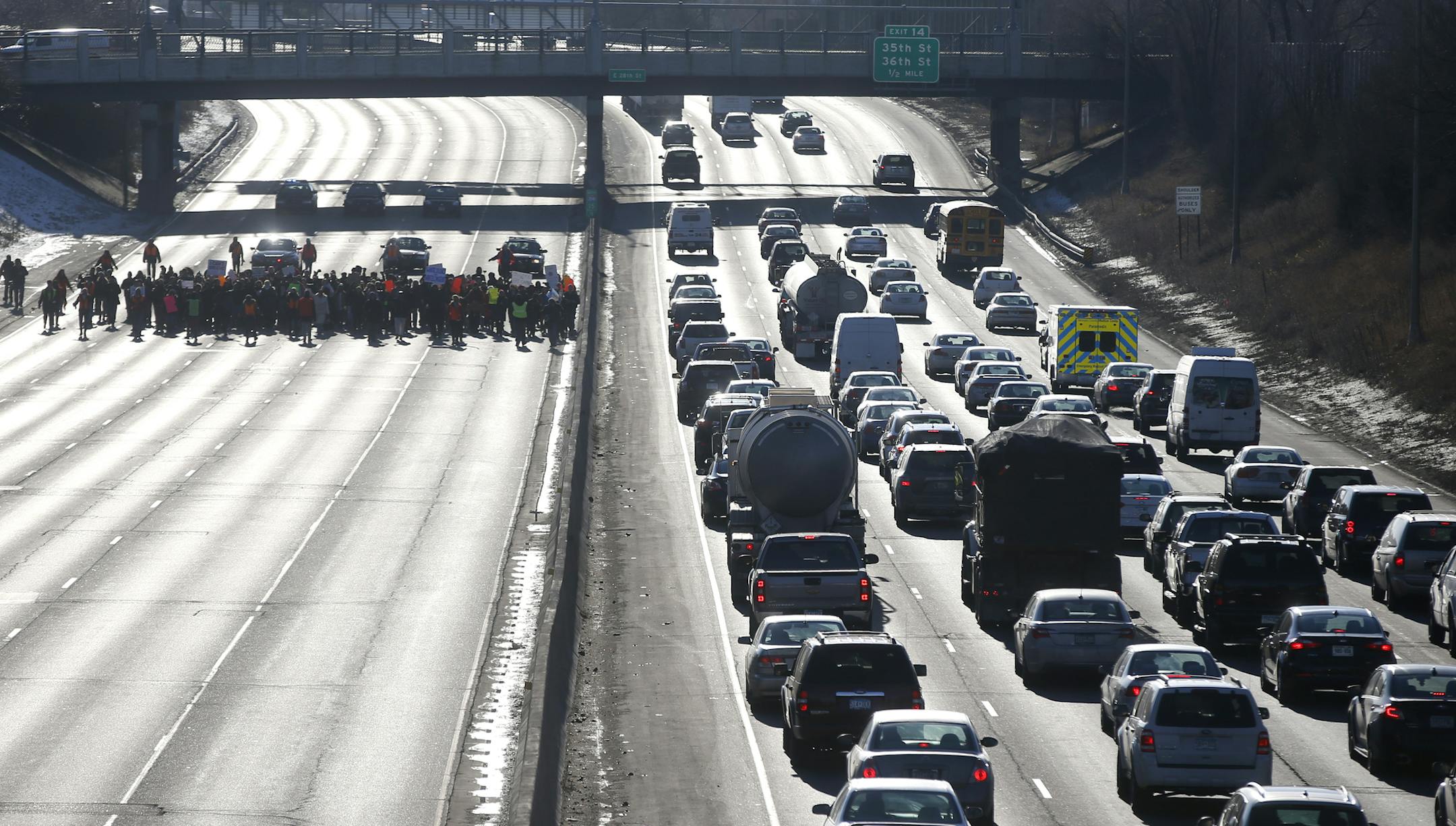 Protesters in Minneapolis MN, shutdown the Northbound lanes of I-35W December 4th, 2014, a day after the Grand Jury declined to Indict NYPD Officer in the chokehold death of Eric Garner. [ Richard Tsong-Taatarii • Richard.Tsong-Taatarii@startribune.com