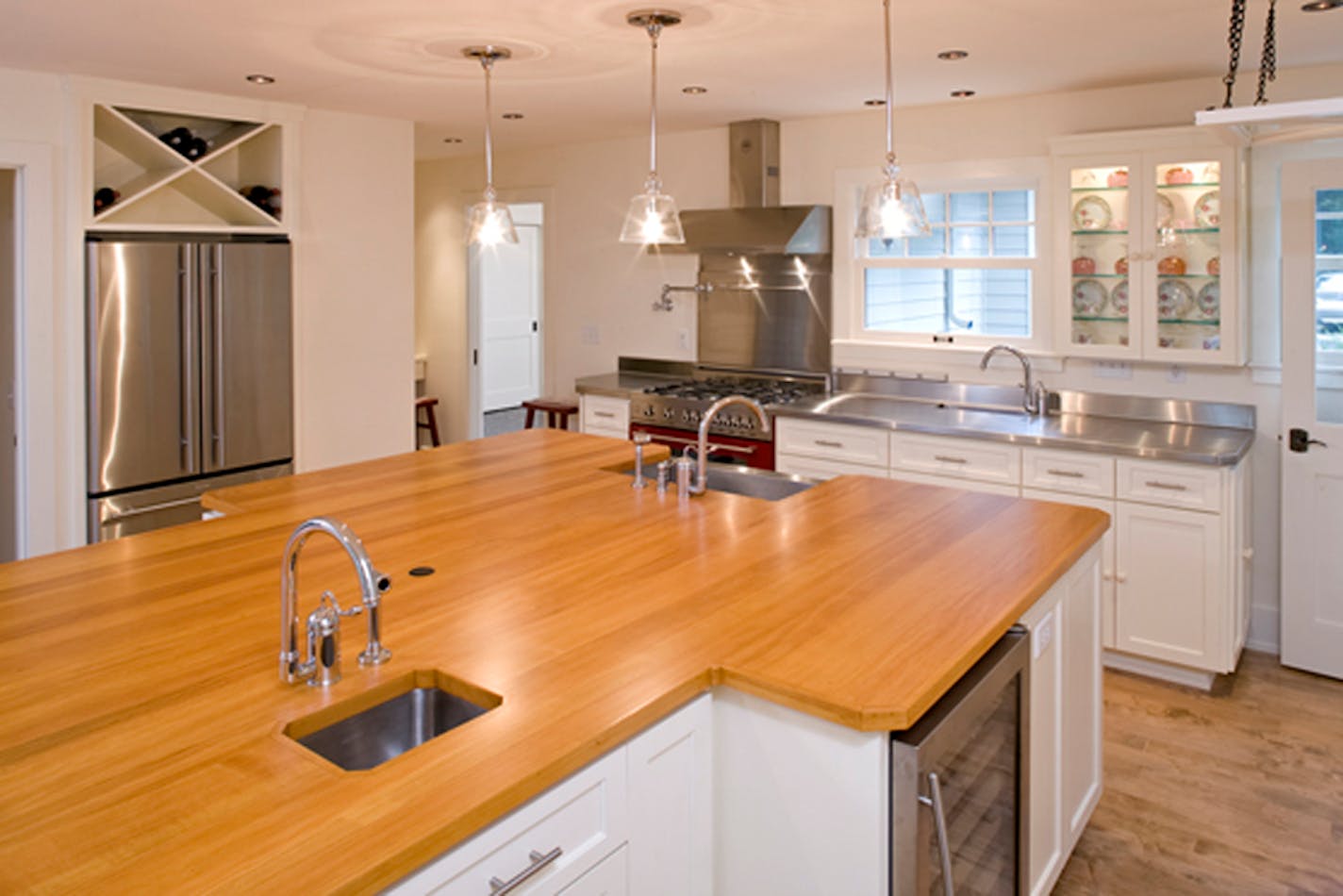 The kitchen layout — including sinks and work stations with room for several people — is similar to one the owner had in her apartment overlooking the Mediterranean Sea.