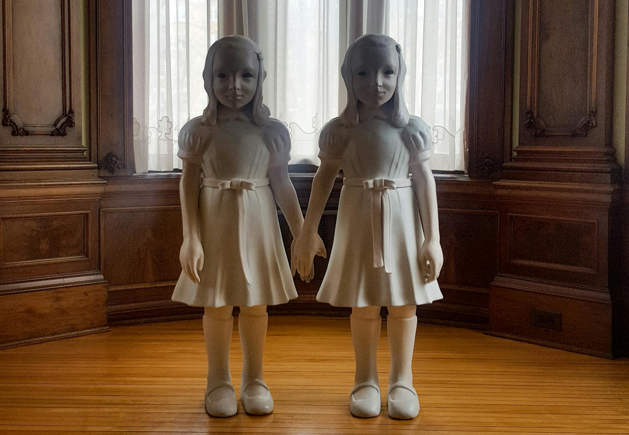 Kim Simonsson's "Lisa and Louisa" stands at the end of a hallway at the American Swedish Institute.