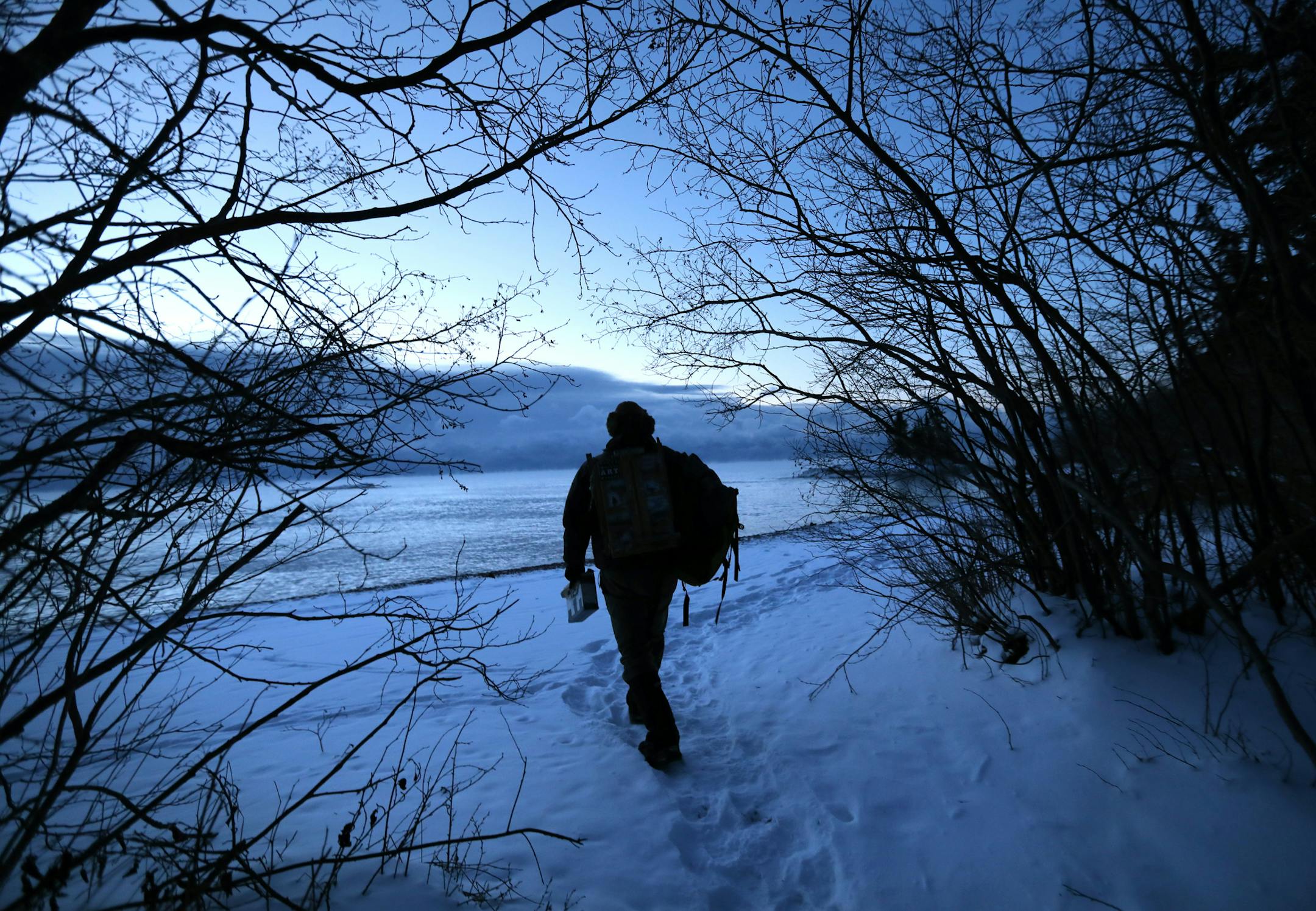 Plein Air painter Neil Sherman, ventures into the outdoors, even in the extremes, to paint and create. Here, Sherman hikes to the shore of Lake Superior north of Grand Marais before sunrise on a recent frigid morning. (-8 degrees).] brian.peterson@startribune.com
Grand Marais, MN 01/08/17