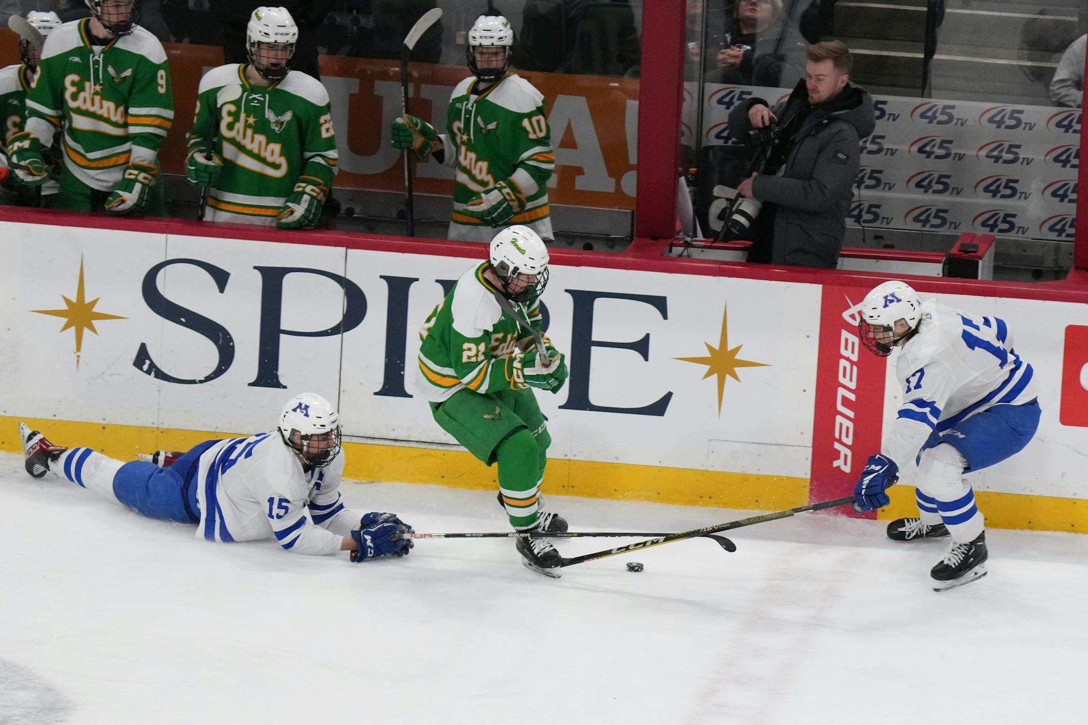 Edina forward Bobby Cowan (21) tries to skate through Minnetonka forward Sam Scheetz (21) and Minnetonka defenseman Liam Hupka (17) in the first period.