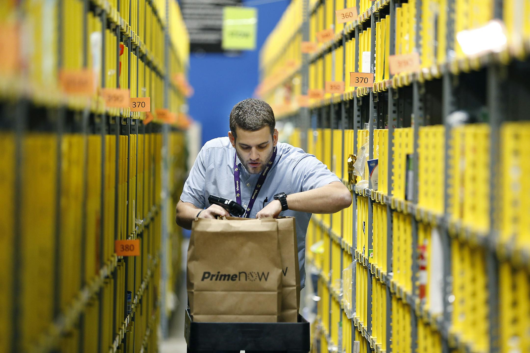 Jonathan Kretman prepared deliveries Thursday at Amazon' s Prime Now hub in Minneapolis from which deliveries will flow up through midnight on Christmas Eve.