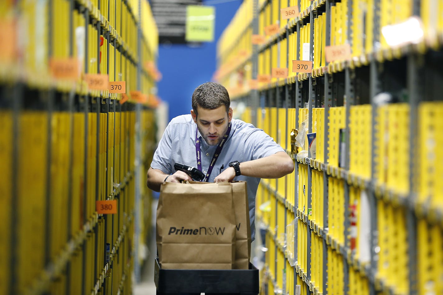 Jonathan Kretman prepared deliveries Thursday at Amazon' s Prime Now hub in Minneapolis from which deliveries will flow up through midnight on Christmas Eve.