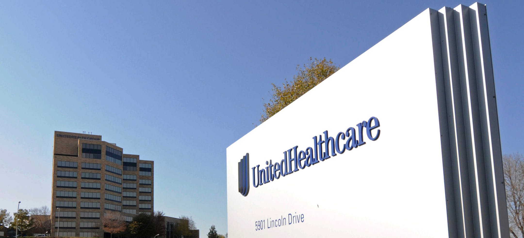 FILE - This Oct. 16, 2012, file photo, shows a portion of the UnitedHealth Group Inc.'s campus in Minnetonka, Minn. The nation's biggest health insurer is expanding a program that passes rebates from drugmakers directly to the people that use their medications. UnitedHealthcare said Tuesday, March 12, 2019, that next year, all of its new, employer-sponsored healthcare plans must give point-of-sale discounts to consumers when they pick up medications. (AP Photo/Jim Mone, File)