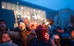 The crowd lights their sparklers from one another at the Winter Solstice celebration at the American Swedish Institute on Dec. 22, 2015. ] Photo by Le