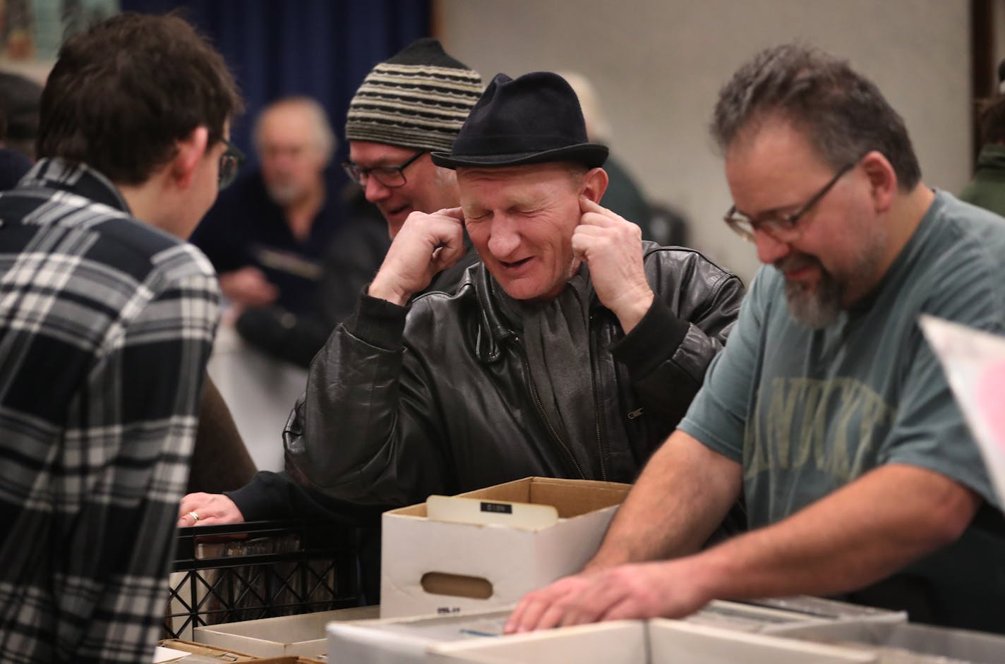 Tony Beeton of Cambridge, England, a former roadie for Motorhead and Ray Davies, plugs his ears to show those around him how he listened to punk bands live in the 1970s.