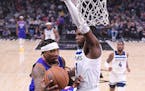 Los Angeles Clippers guard Eric Bledsoe, left, passes the ball as Minnesota Timberwolves forward Anthony Edwards defends during the first half of an N