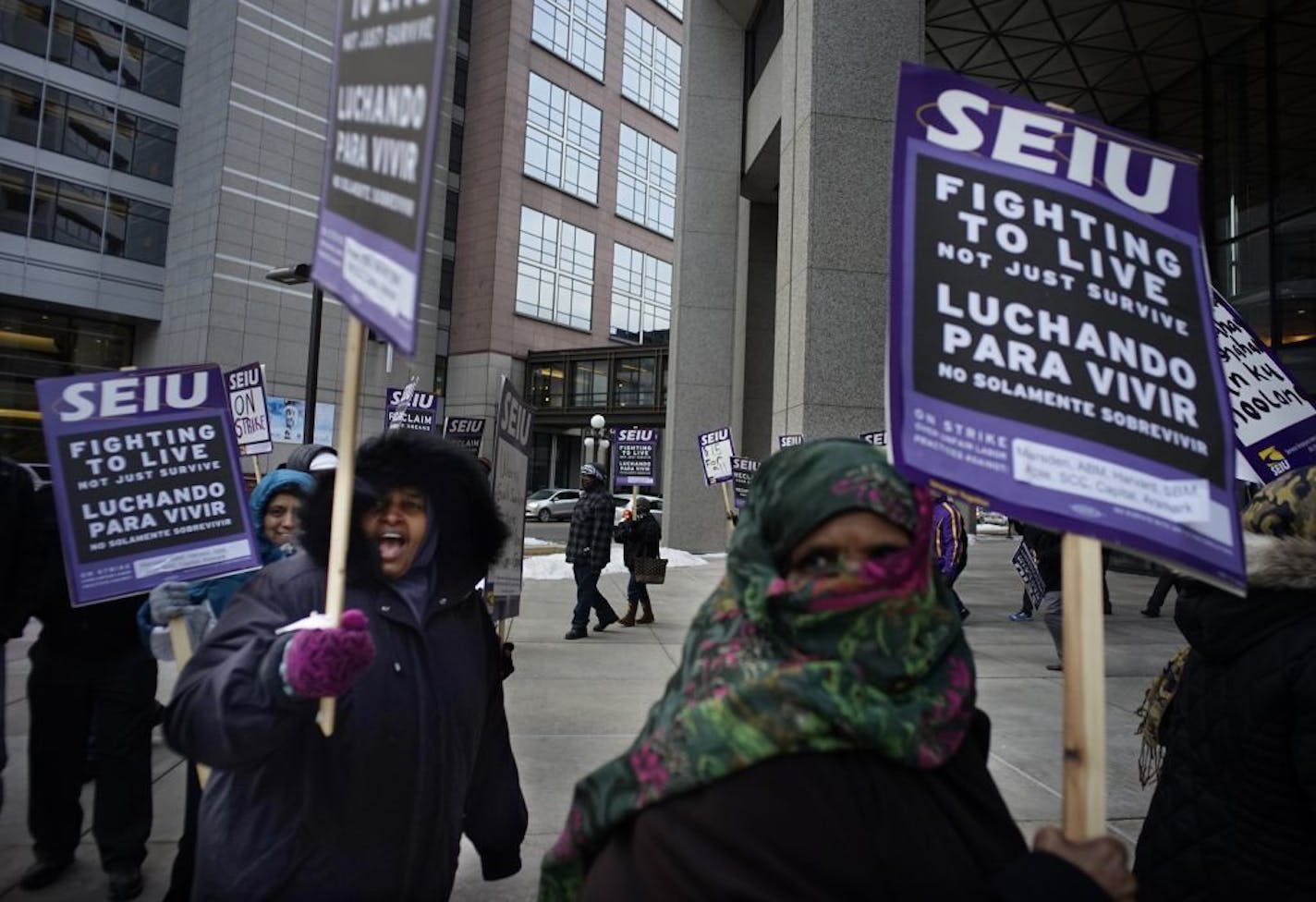 At the Securian Center in downtown St. Paul, several dozen janitors from the SEIU protested their wages .