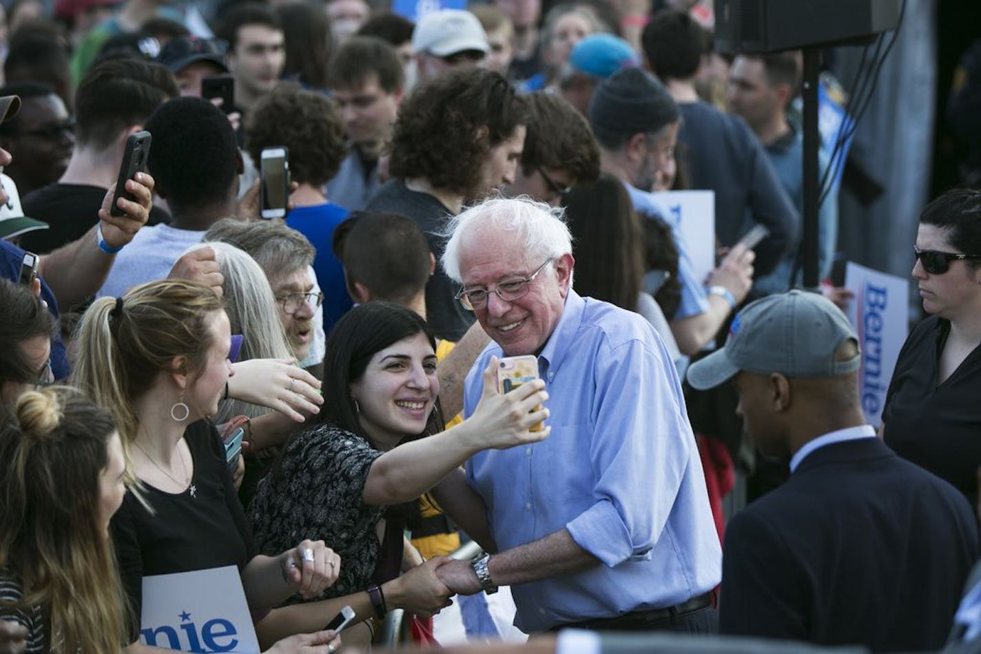 Sen. Bernie Sanders (I-Vt.), a candi­date for the Democratic presidenti­al nomin­ation, takes a photo with a fan after speaking at a rally in Pittsburgh, April 14, 2019.