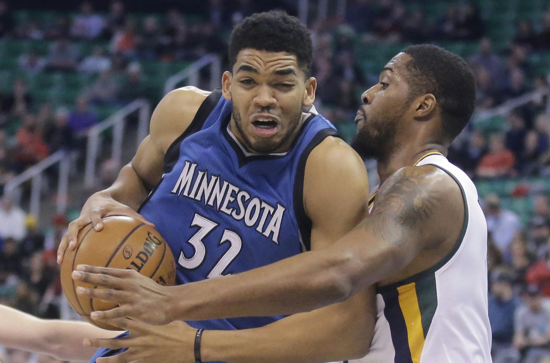 Utah Jazz forward Derrick Favors, right, defends against Minnesota Timberwolves center Karl-Anthony Towns (32) during the first half in an NBA basketball game Wednesday, March 1, 2017, in Salt Lake City. (AP Photo/Rick Bowmer)