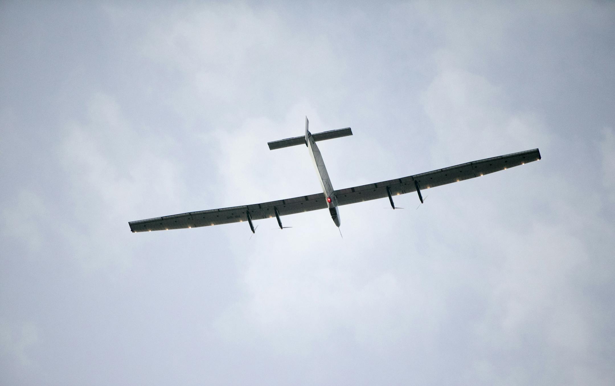 The Solar Impulse 2, a solar-powered airplane, circles the Kalaeloa Airport, Friday, July 3, 2015, in Kapolei, Hawaii. The plane, piloted by Andre Borschberg, is attempting to fly around the world without fuel.