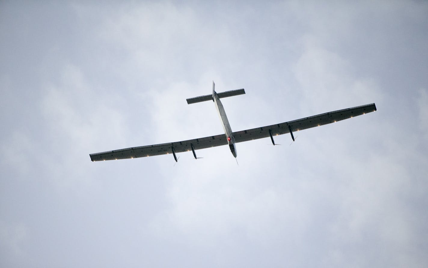 The Solar Impulse 2, a solar-powered airplane, circles the Kalaeloa Airport, Friday, July 3, 2015, in Kapolei, Hawaii. The plane, piloted by Andre Borschberg, is attempting to fly around the world without fuel.