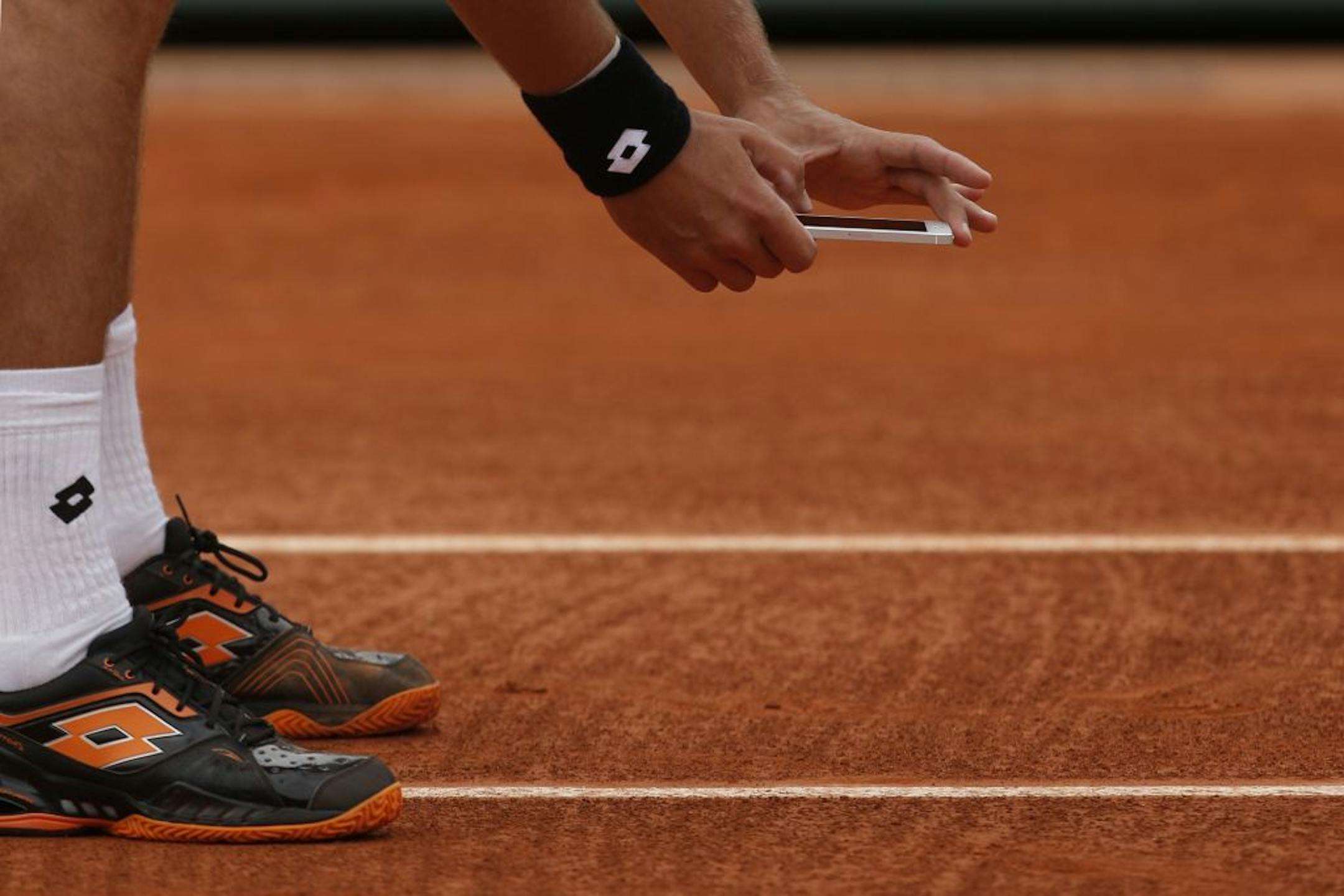 Ukraine's Sergiy Stakhovsky takes a picture with his smart phone after contesting the decision of the umpire to call the ball in, in his first round match against Richard Gasquet of France at the French Open tennis tournament, in Roland Garros stadium in Paris, Monday, May 27, 2013.