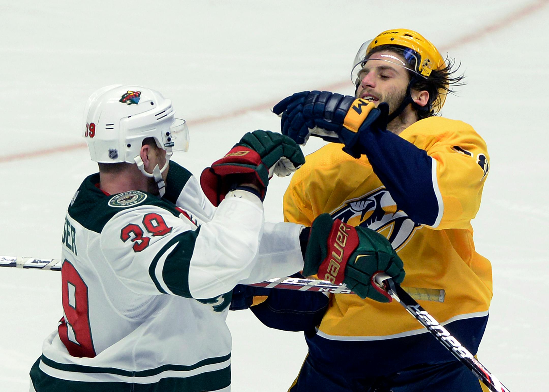 Minnesota Wild defenseman Nate Prosser (39) shoves Nashville Predators right wing Ryan Hartman, right, during the second period of an NHL hockey game Tuesday, March 27, 2018, in Nashville, Tenn. (AP Photo/Mark Zaleski)