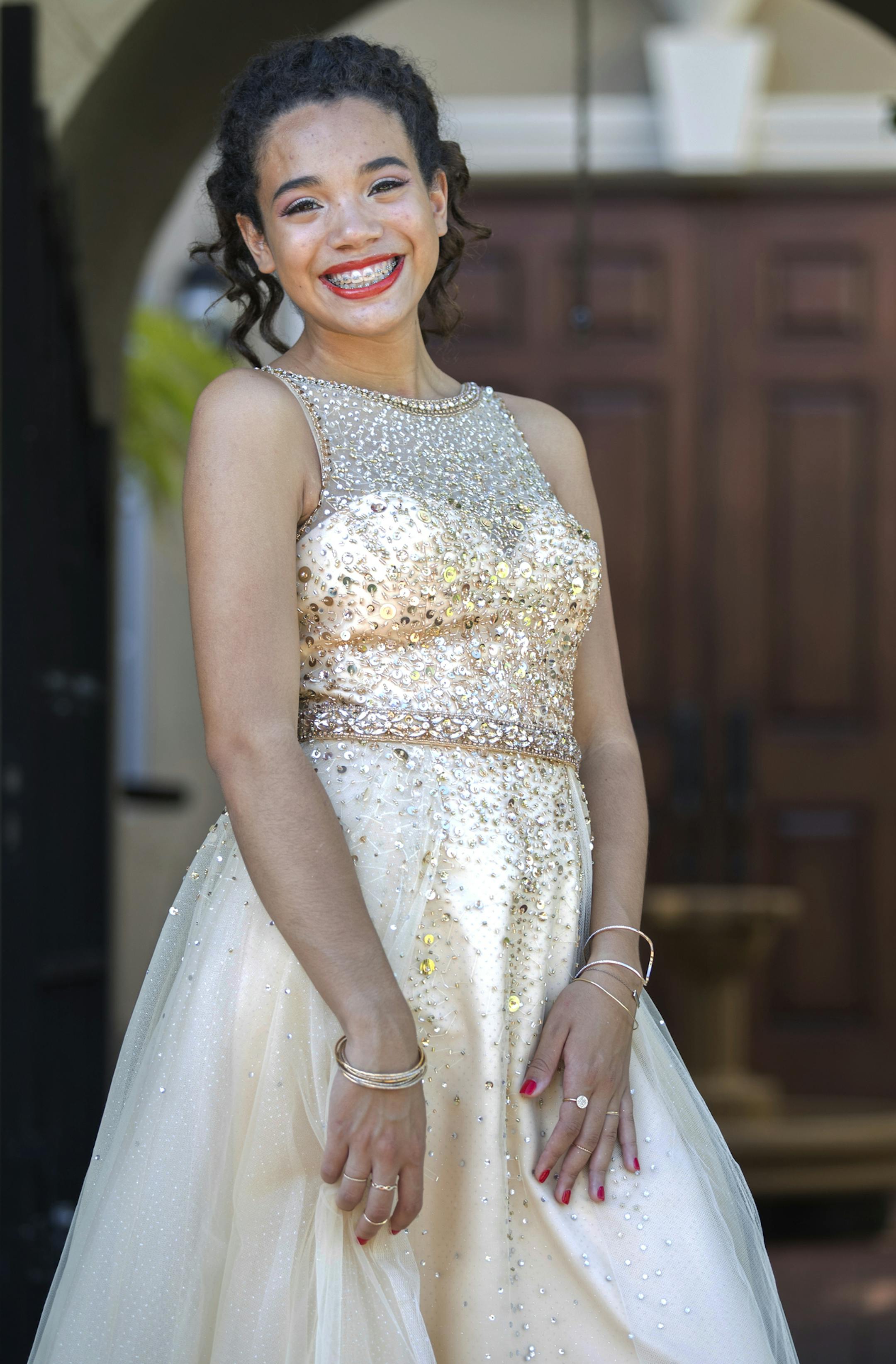 In a Saturday, May 5, 2018 photo, Stoneman Douglas senior Nicole Barreto is ready for her prom in Parkland, Fla. Nicole, a member of the band, was good friends with Carmen Schentrup, one of the 17 victims of the shooting. (Jennifer Lett/South Florida Sun-Sentinel via AP)