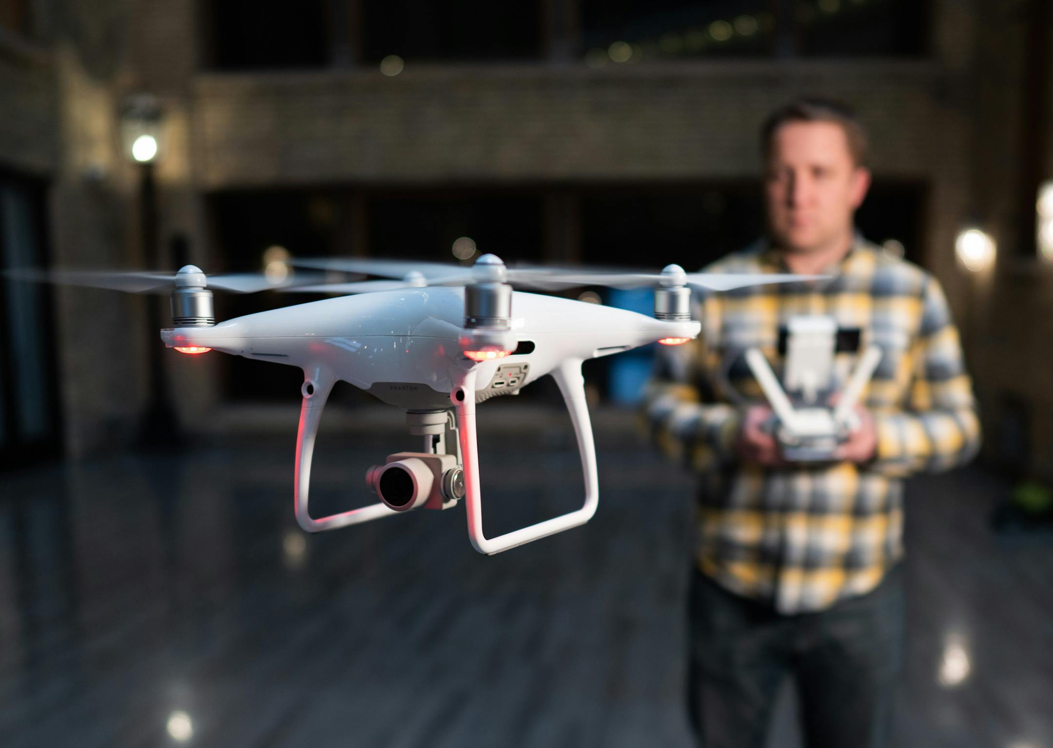 Tyler Mason poses for a portrait with a DJI Phantom, a popular consumer drone. ] MARK VANCLEAVE ï mark.vancleave@startribune.com * Tyler Mason is the director of digital media at AirVuz, a Minneapolis-based online drone video platform and production company. Photographed Tuesday, Nov. 20, 2018 outside the AirVuz headquarters in the Lumber Exchange building.