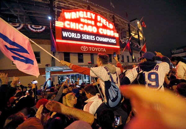 Chicago Cubs fans celebrated in front of Wrigley Field in Chicago on Wednesday after the Cubs defeated the Cleveland Indians 8-7 in Game 7 of the Worl