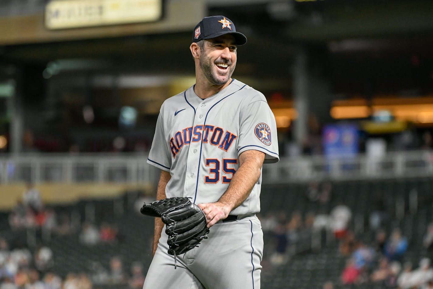 Houston Astros pitcher Justin Verlander smiles as he heads to the dugout after completing eight innings and allowing the Minnesota Twins only one hit during the eighth inning of a baseball game, Tuesday, May 10, 2022, in Minneapolis. (AP Photo/Craig Lassig)