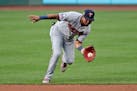 Minnesota Twins' Luis Arraez fields a ball hit by Cleveland Indians' Jose Ramirez in the first inning in a baseball game, Monday, Aug. 24, 2020, in Cl