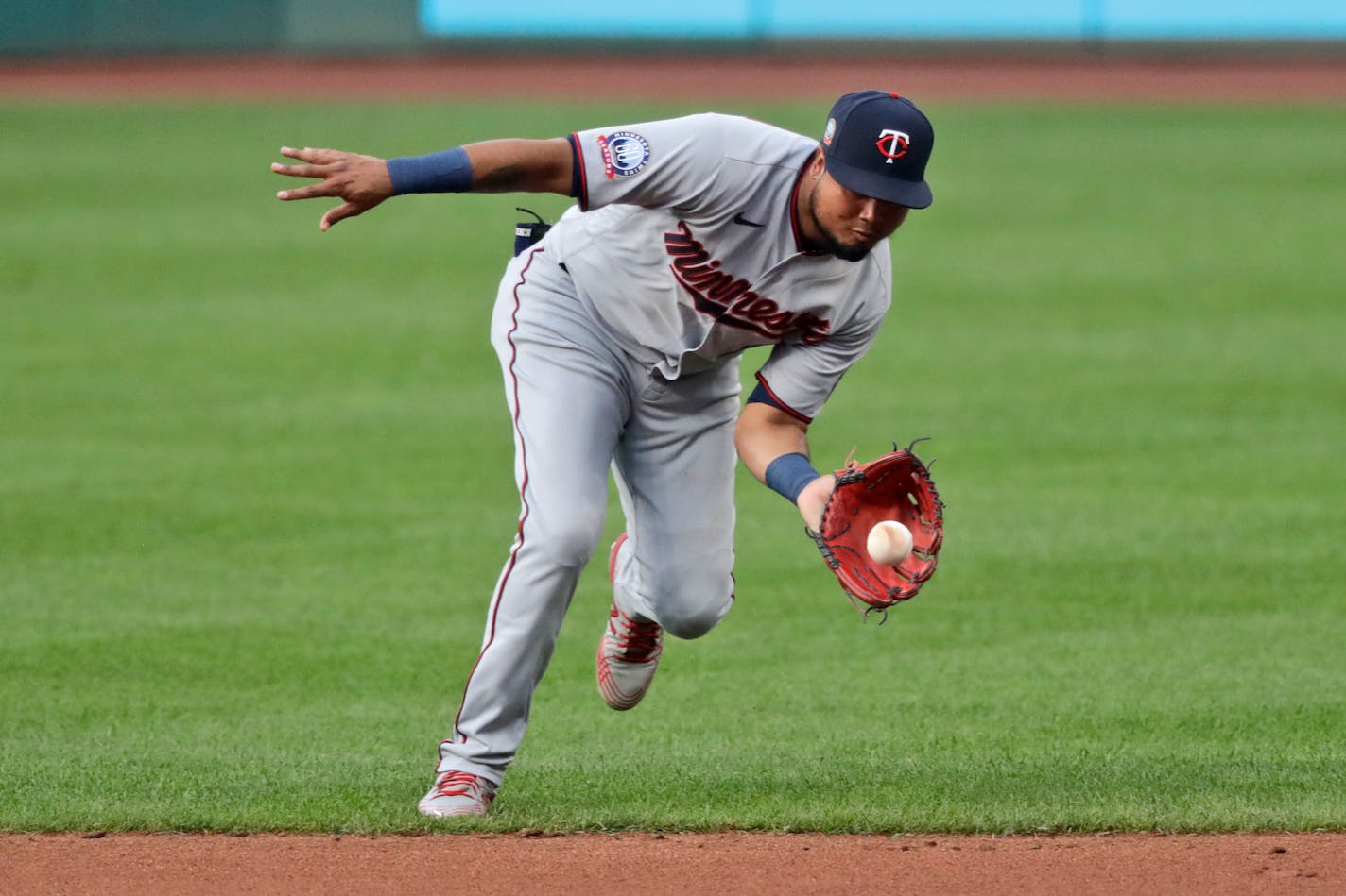 Minnesota Twins' Luis Arraez fields a ball hit by Cleveland Indians' Jose Ramirez in the first inning in a baseball game, Monday, Aug. 24, 2020, in Cleveland. Ramiorez was out the play. (AP Photo/Tony Dejak)