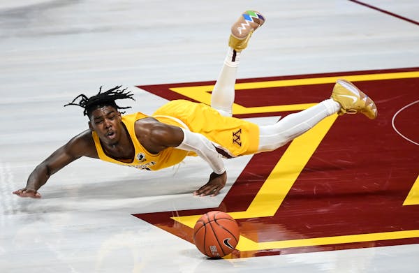 Minnesota Gophers guard Marcus Carr (5) fell to the court as he lost control of the ball in the second half against the Northwestern Wildcats.