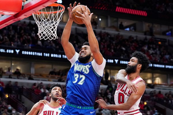 Timberwolves center Karl-Anthony Towns (32) grabs a rebound against the Bulls.