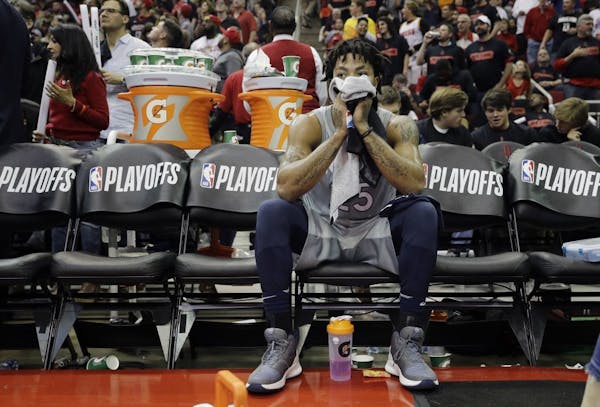 Derrick Rose sits on the bench during a timeout against the Rockets