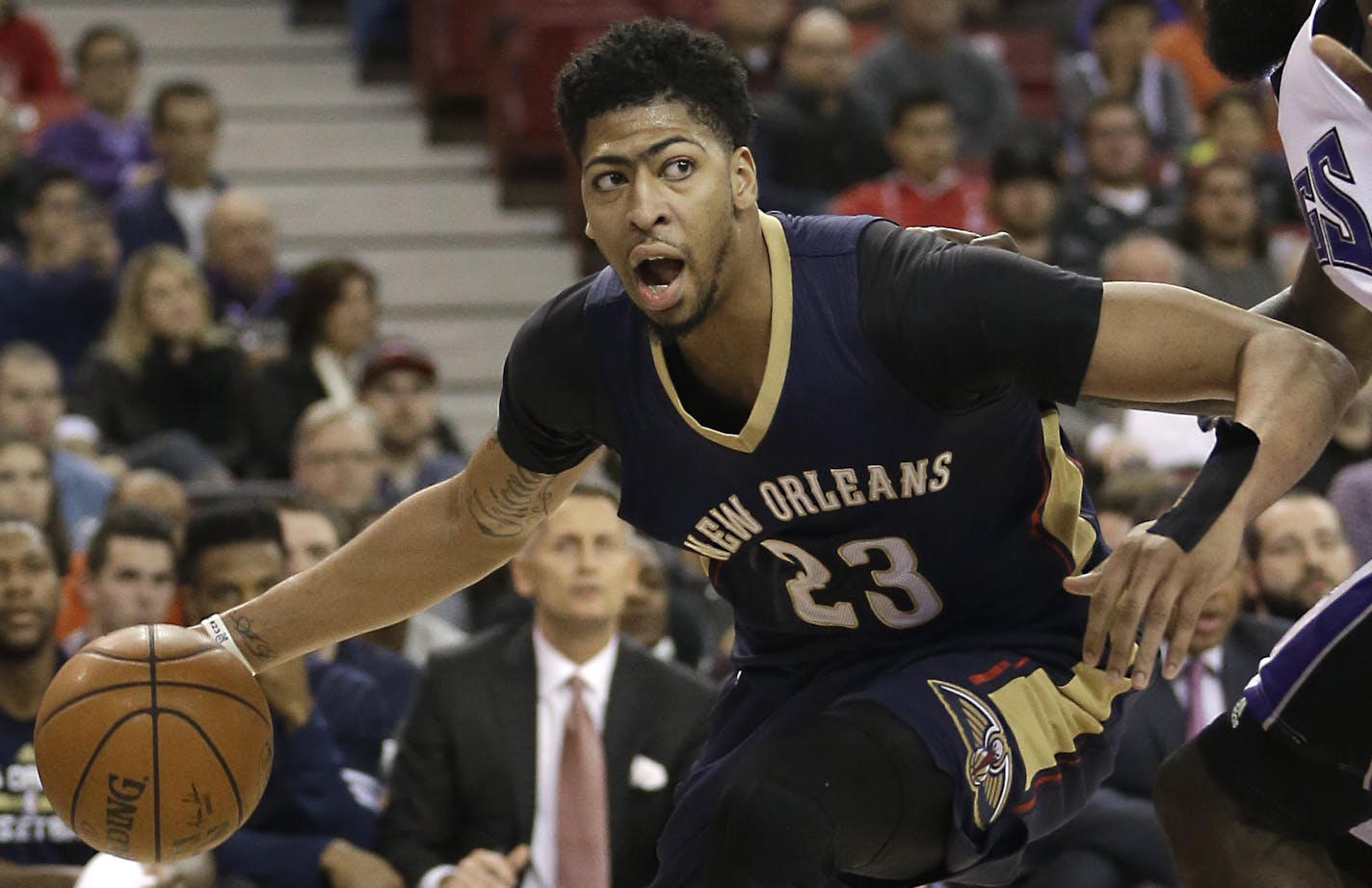 New Orleans Pelicans forward Anthony Davis, left, drives against Sacramento Kings forward Quincy Acy during the first quarter of an NBA basketball game, Wednesday, Jan. 13, 2016, in Sacramento, Calif.(AP Photo/Rich Pedroncelli) ORG XMIT: OTKRP104