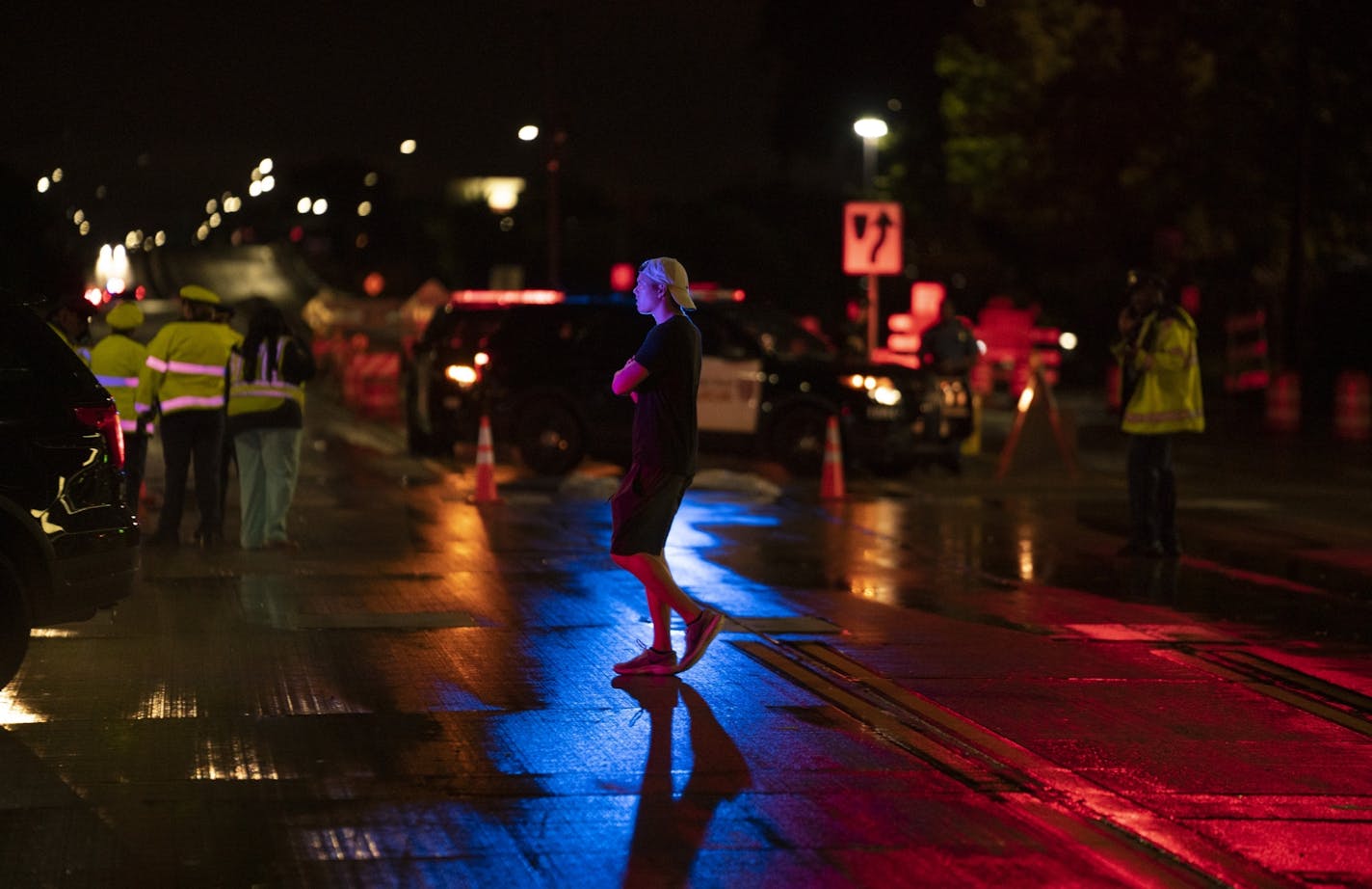 Police vehicles remained at the intersection of Midway Parkway and Snelling Ave. near the main entrance to the Minnesota State Fair grounds late Monday night after a shooting and a person reportedly was hit by a car near the same location.