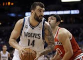 Minnesota Timberwolves' Nikola Pekovic, left, of Montenegro, is closely watched by Milwaukee Bucks' Zaza Pachulia of Georgia in the first quarter of a