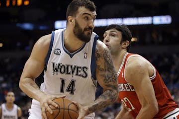 Minnesota Timberwolves' Nikola Pekovic, left, of Montenegro, is closely watched by Milwaukee Bucks' Zaza Pachulia of Georgia in the first quarter of a