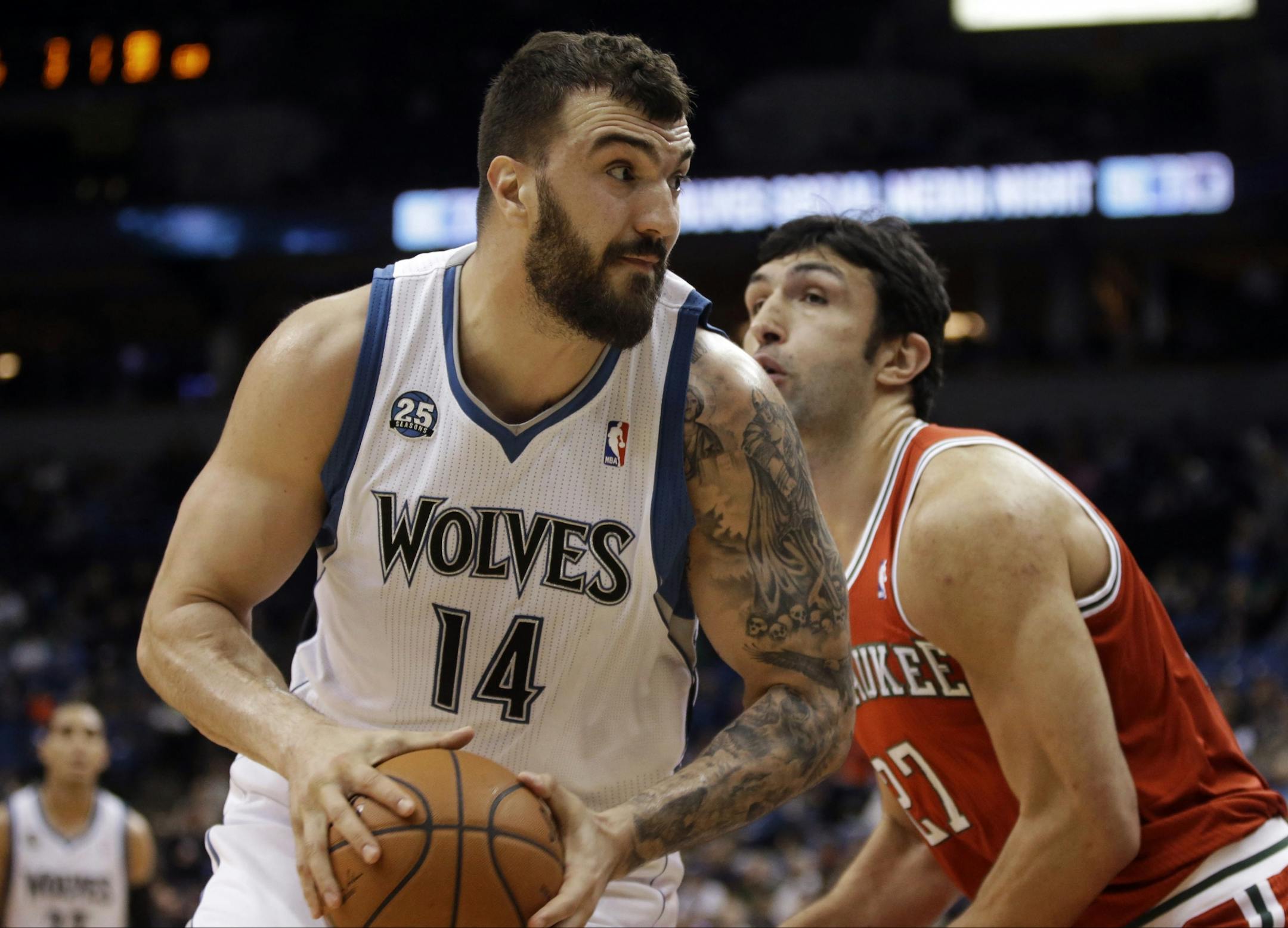 Minnesota Timberwolves' Nikola Pekovic, left, of Montenegro, is closely watched by Milwaukee Bucks' Zaza Pachulia of Georgia in the first quarter of an NBA basketball game, Tuesday, March 11, 2014, in Minneapolis.
