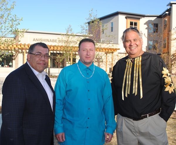 Paul Williams, CEO of Project for Pride In Living, from left, resident Gabriel Corbesia and CEO Michael Goze of the American Indian Community Developm