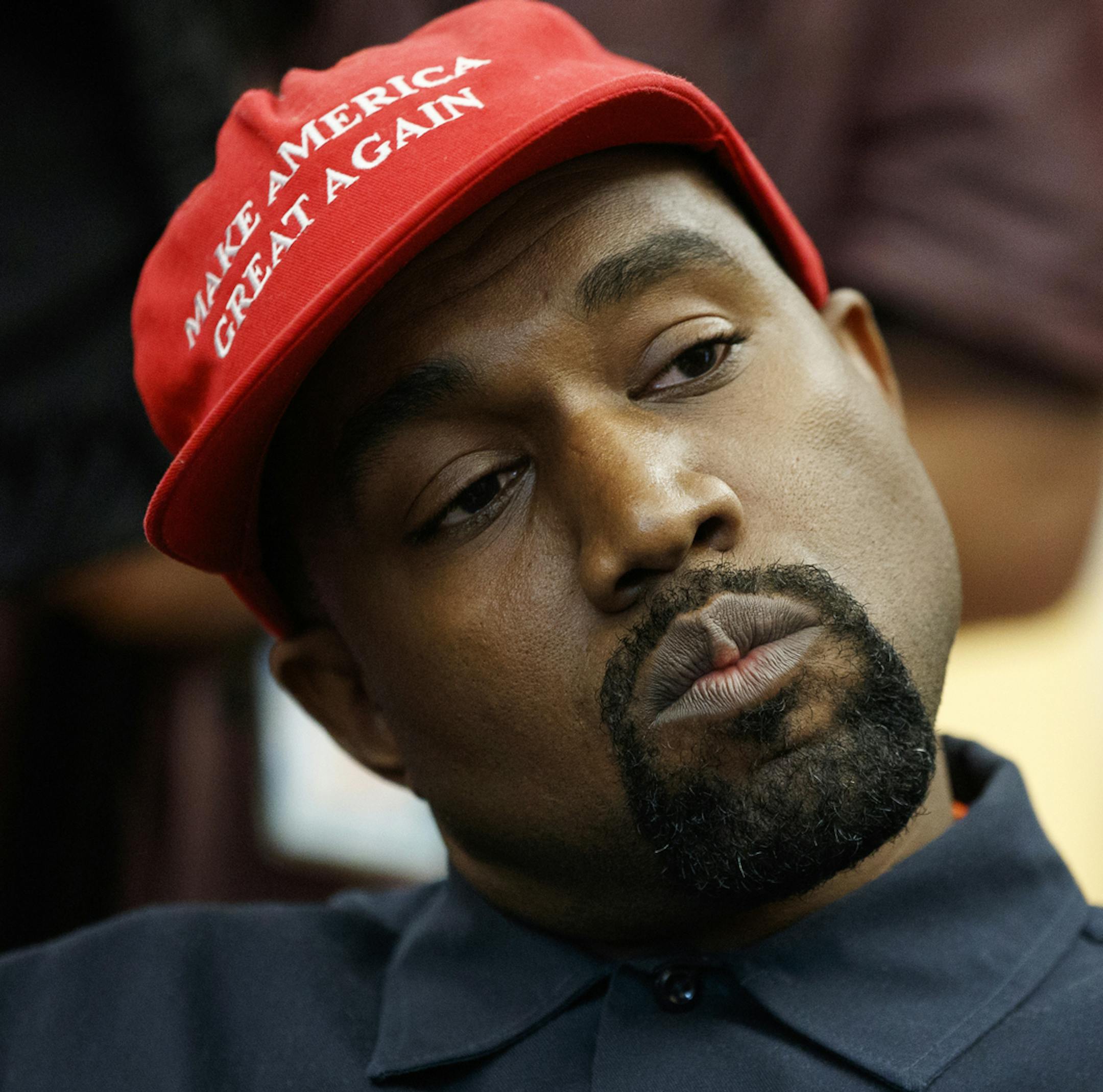 FILE - In this Oct. 11, 2018, file photo rapper Kanye West listens to a question from a reporter during a meeting in the Oval Office of the White House with President Donald Trump in Washington. On Sunday, Aug. 25, 2019, Kanye West hosted a Sunday Service in Ohio in support of those affected by the recent mass shooting. A large crowd gathered at the service in a park in Dayton. (AP Photo/Evan Vucci, File)