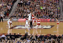 Duke's Jahlil Okafor (15) and Wisconsin's Frank Kaminsky (44) battle for the ball at the tip off during the first half of the NCAA Final Four college 