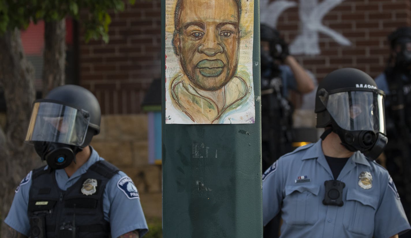 Minnesota police stand outside the department's 3rd Precinct on Wednesday, May 27, 2020, in Minneapolis. The mayor of Minneapolis called Wednesday for criminal charges against the white police officer seen on video kneeling against the neck of Floyd George, a handcuffed black man who complained that he could not breathe and died in police custody. (Carlos Gonzalez/Star Tribune via AP)