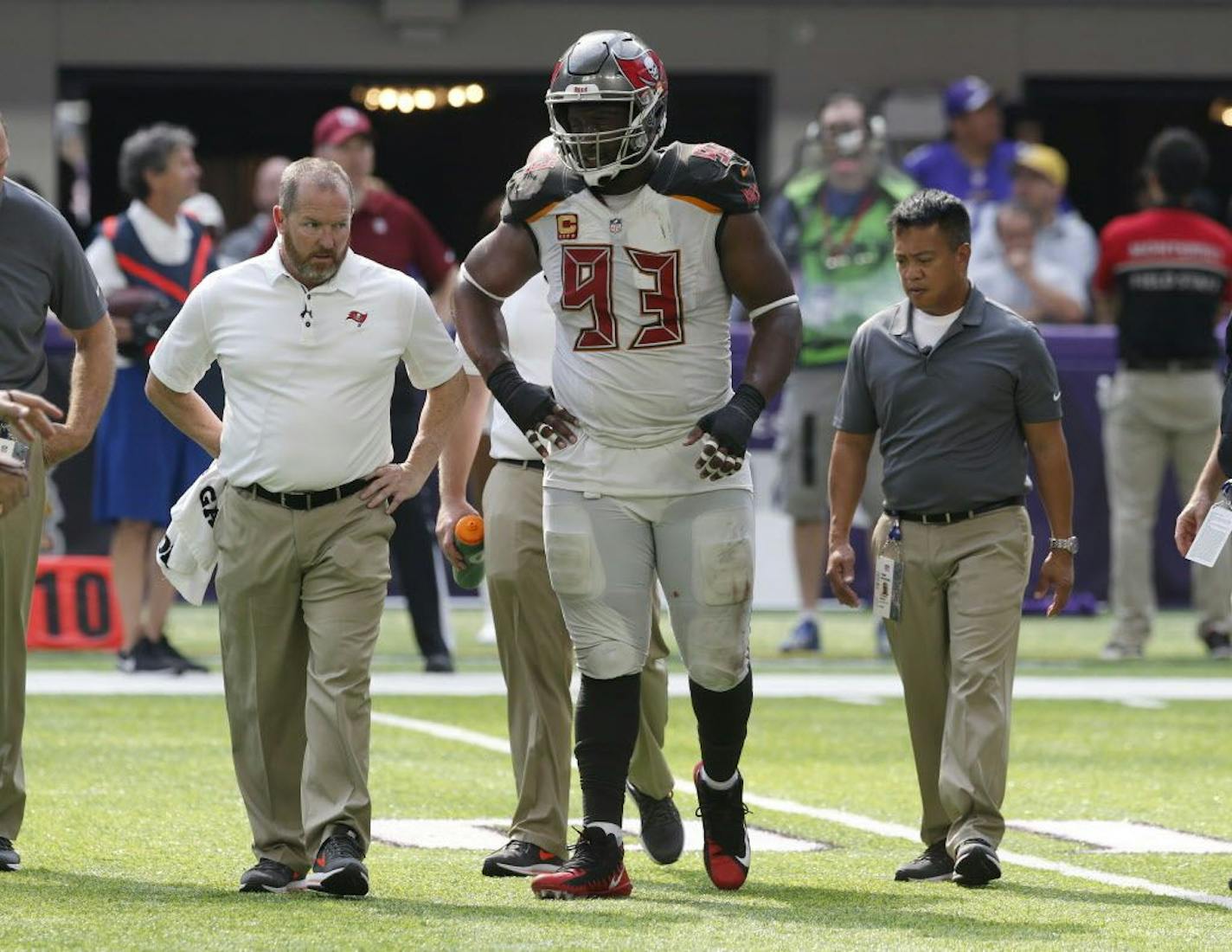 Tampa Bay Buccaneers defensive tackle Gerald McCoy (93) is helped off the field after getting injured during the second half of an NFL football game against the Minnesota Vikings, Sunday, Sept. 24, 2017, in Minneapolis.