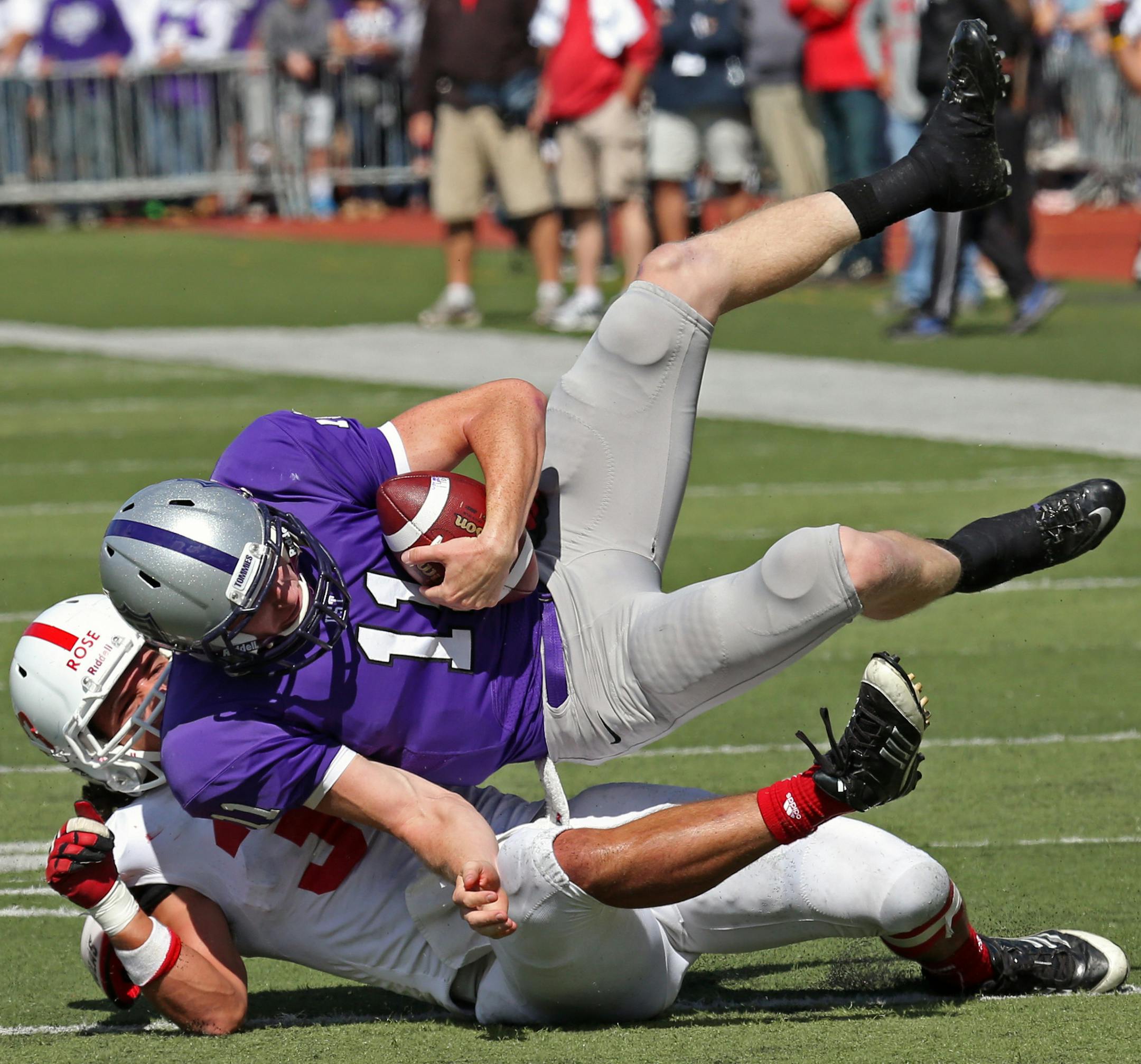 St. Thomas vs. St. Johns, St. Paul, MN., 9/21/13. (left to right) St. John's linebacker Andrew Rose sacked St. Thomas quarterback Matt OConnell in 2nd half action.] Bruce Bisping/Star Tribune bbisping@startribune.com Andrew Rose, Matt O'Connell/roster.