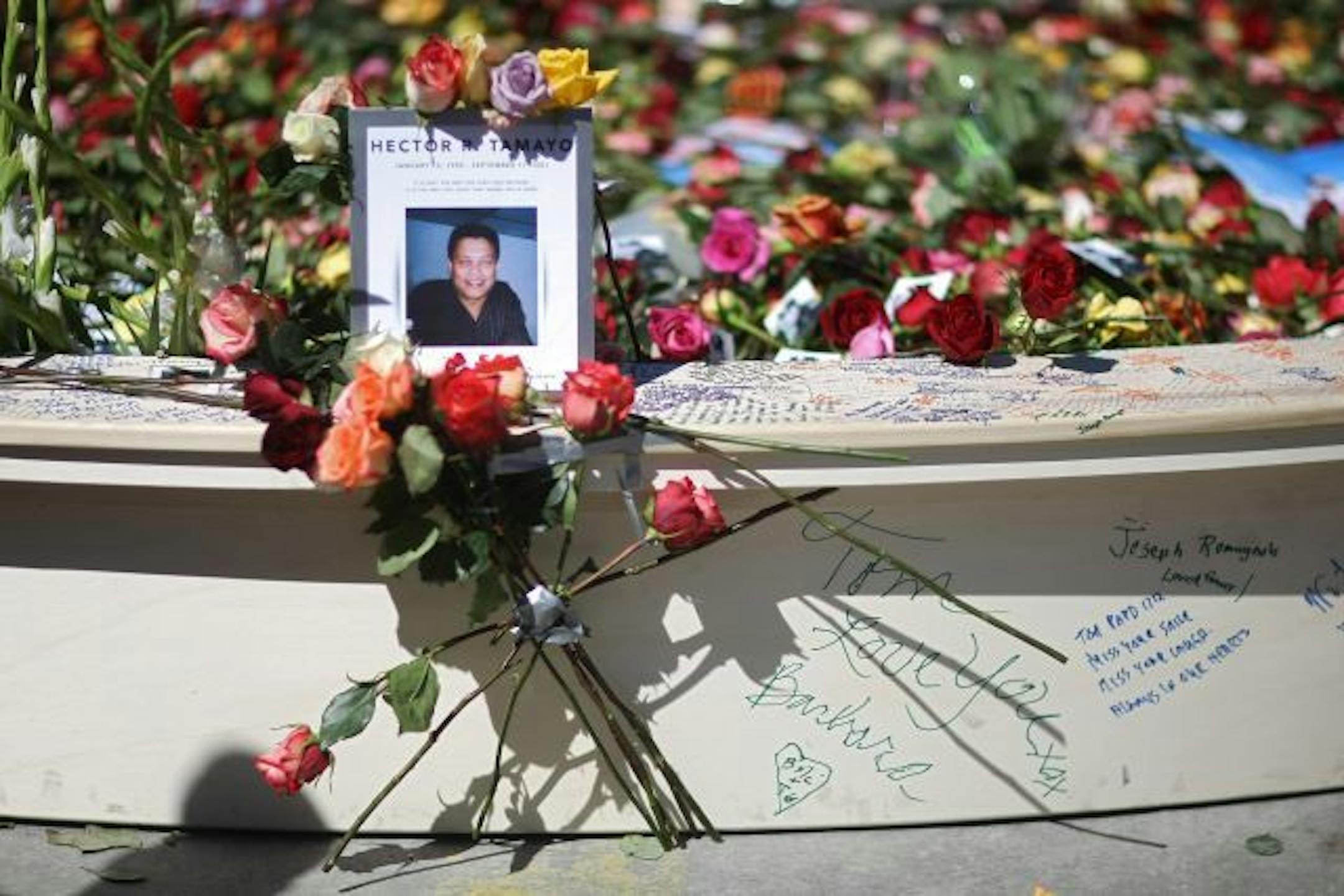 Floral tributes and remembrances left at the reflecting pool at Ground Zero in New York.